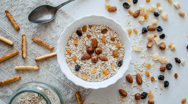 Healthy snacks at a desk including nuts and granola for work