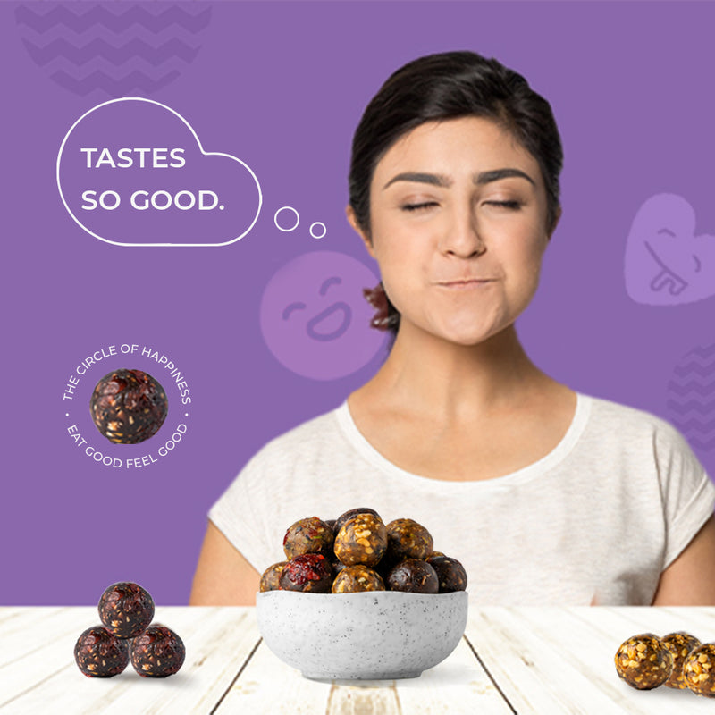 Cocoa Cherry Carnival bliss balls in a bowl showing cocoa solids and cherries
